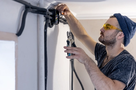 Electrician repairing wall wiring