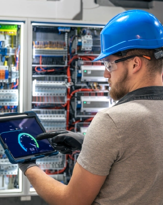 Technician inspecting electrical panel